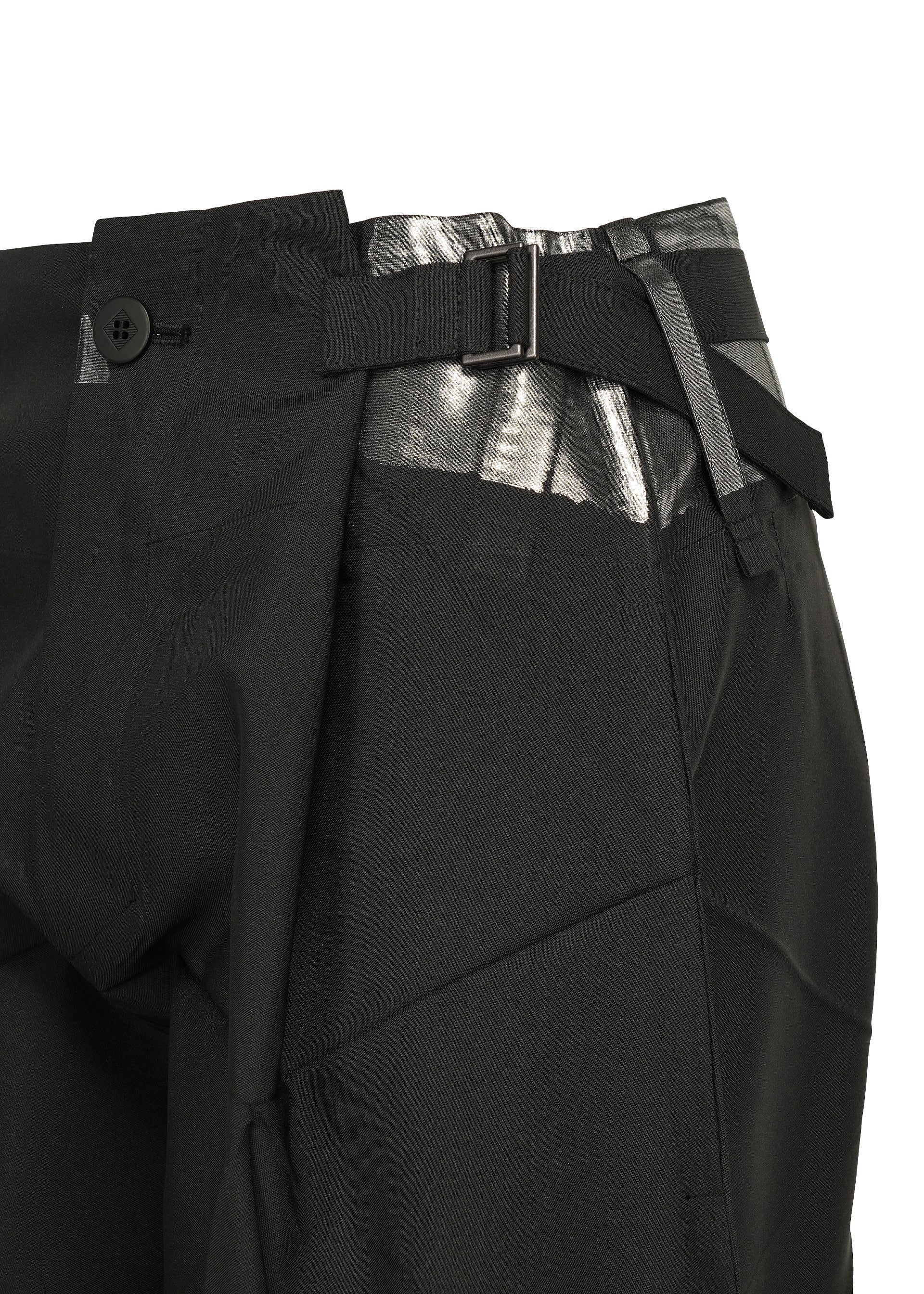 Zoomed view Close-up of the F-BT black tailored recycled polyester pants by 132 5. ISSEY MIYAKE, featuring a silver metallic waistband detail, foil processing, side buckle, and black button closure against a white background.