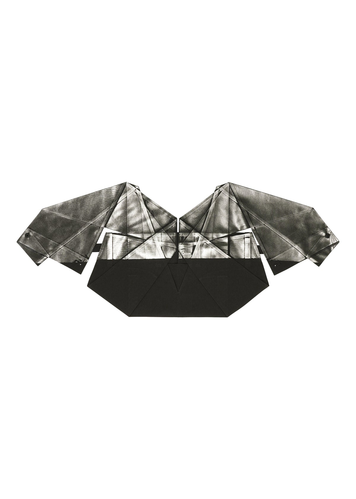 The F-BT by 132 5. ISSEY MIYAKE is an origami sculpture with angular wings and a geometric body, crafted from black and silver foil processing paper, resembling a stylized bat or bird against a white background. view 7 of 13
