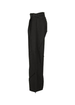 The F-BT pants by 132 5. ISSEY MIYAKE are black, high-waisted, wide-leg trousers with a belted waist and geometric seam details, made from recycled polyester. Shown side view against a white background.