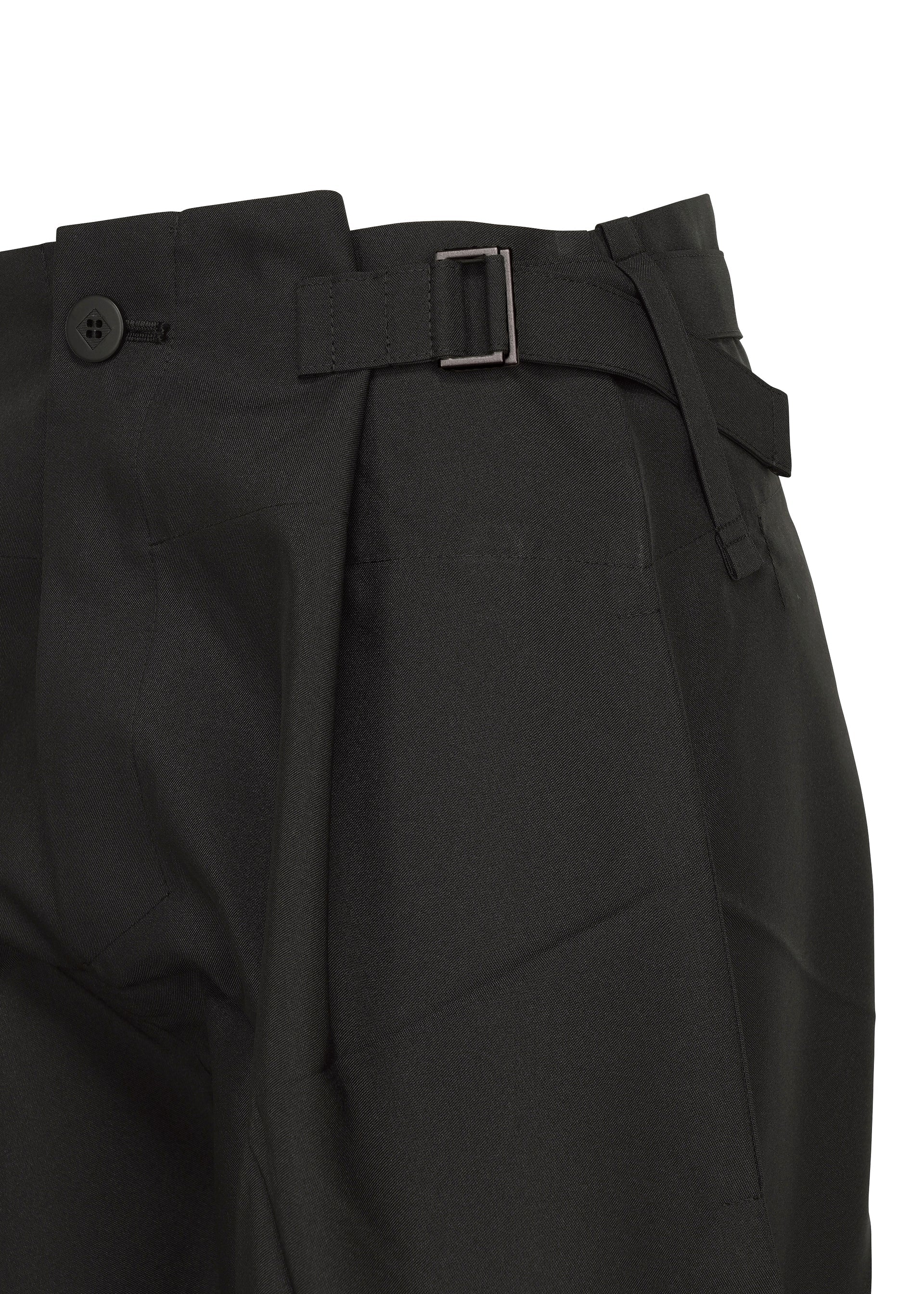 Zoomed view Close-up of F-BT black recycled polyester pants by 132 5. ISSEY MIYAKE, featuring a side adjuster strap with metal buckle, button closure at the waistband, and structured, slightly textured fabric.