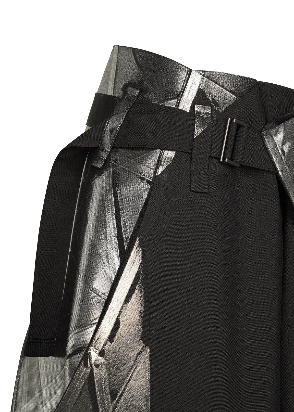Close-up of the F-BT black skirt by 132 5. ISSEY MIYAKE, featuring a wide belt with a rectangular metal buckle, abstract silver and gray geometric print, and subtle foil detailing for shine. view 4 of 9