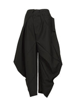 The F-BT by 132 5. ISSEY MIYAKE are black, recycled polyester pants with avant-garde wide legs, sculptural draping, asymmetrical folds, a high waist, and cropped hem for a bold, structured look.