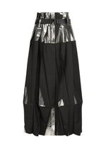 The No.3-1 by 132 5. ISSEY MIYAKE is a knee-length black skirt with wide pleats, shiny metallic foil details at the waistband and hem, and a black buckle belt—styled for an edgy look inspired by foil detail pants.