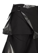 A close-up of the No.1-2 skirt by 132 5. ISSEY MIYAKE showcases its black foil fabric with a silver metallic sheen, featuring layered, angular panels and a black belt with a rectangular buckle. Expertly crafted from recycled polyester, this piece presents an eye-catching flared silhouette that elevates any modern wardrobe.