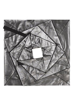 No.1-2 by 132 5. ISSEY MIYAKE is an abstract geometric artwork featuring overlapping metallic silver triangles and rectangles with a central square cutout, set against a white background. Black, ribbon-like elements extend from the shapes, evoking dynamic movement reminiscent of a flared silhouette inspired by a foil skirt.