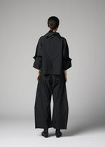A person stands facing away, wearing the F-SH-1 shirt from 132 5. ISSEY MIYAKE. The light gray background highlights the unique geometric folds and structured design of this loose-fitting black piece.