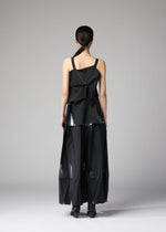 A person stands facing away, wearing the No.1-1 set by 132 5. ISSEY MIYAKE: a geometric black recycled polyester top with asymmetrical folds and wide-leg pants, featuring sheer panels and sculptural shapes against a plain gray background.