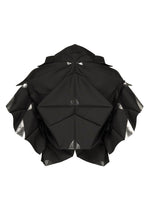 The No.10-1 sculpture by 132 5. ISSEY MIYAKE features black, geometric, origami-inspired folds with angular surfaces and ruffled edges, haori-jacket styling, and metallic silver accents at the creases, set against a white background.