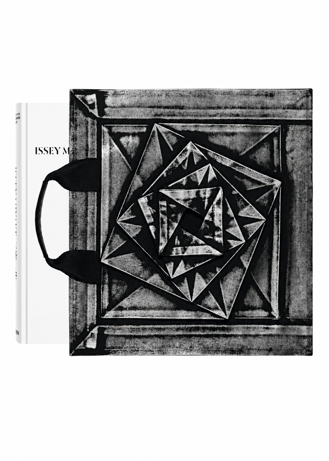 Zoomed view A black-and-white textured tote bag with geometric patterns, inspired by Issey Miyake’s innovative design philosophy, is placed over a white book titled “ISSEY MIYAKE (Limited Collectors Edition)” from ISSEY MIYAKE BOOKS, with the bag’s black handles resting on the left side. - WHITE (no.01)