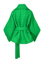 Back view of the ISSEY MIYAKE PLEATED GRID, a bright green quilted jacket with a square pattern, a tie waist, and handmade pleats on the sleeves.