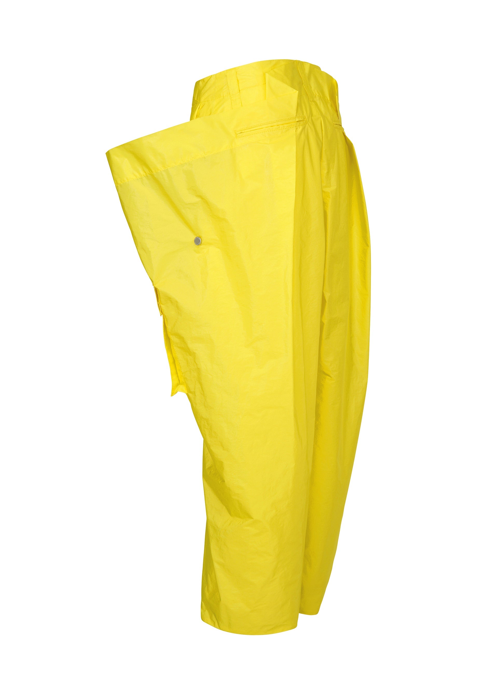 Zoomed view The ISSEY MIYAKE AERIAL STEEL pants are loose-fitting, bright yellow taffeta with a wide side flap and unique, slightly shiny texture, shown on a white background.