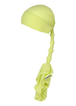 The ISSEY MIYAKE WRAPPED PONYTAIL is a light yellow headwrap with a ponytail silhouette, long textured tail, fabric-wrapped knots, and ruffled ends, shown on a plain white background. - LIGHT GREEN (no.61)