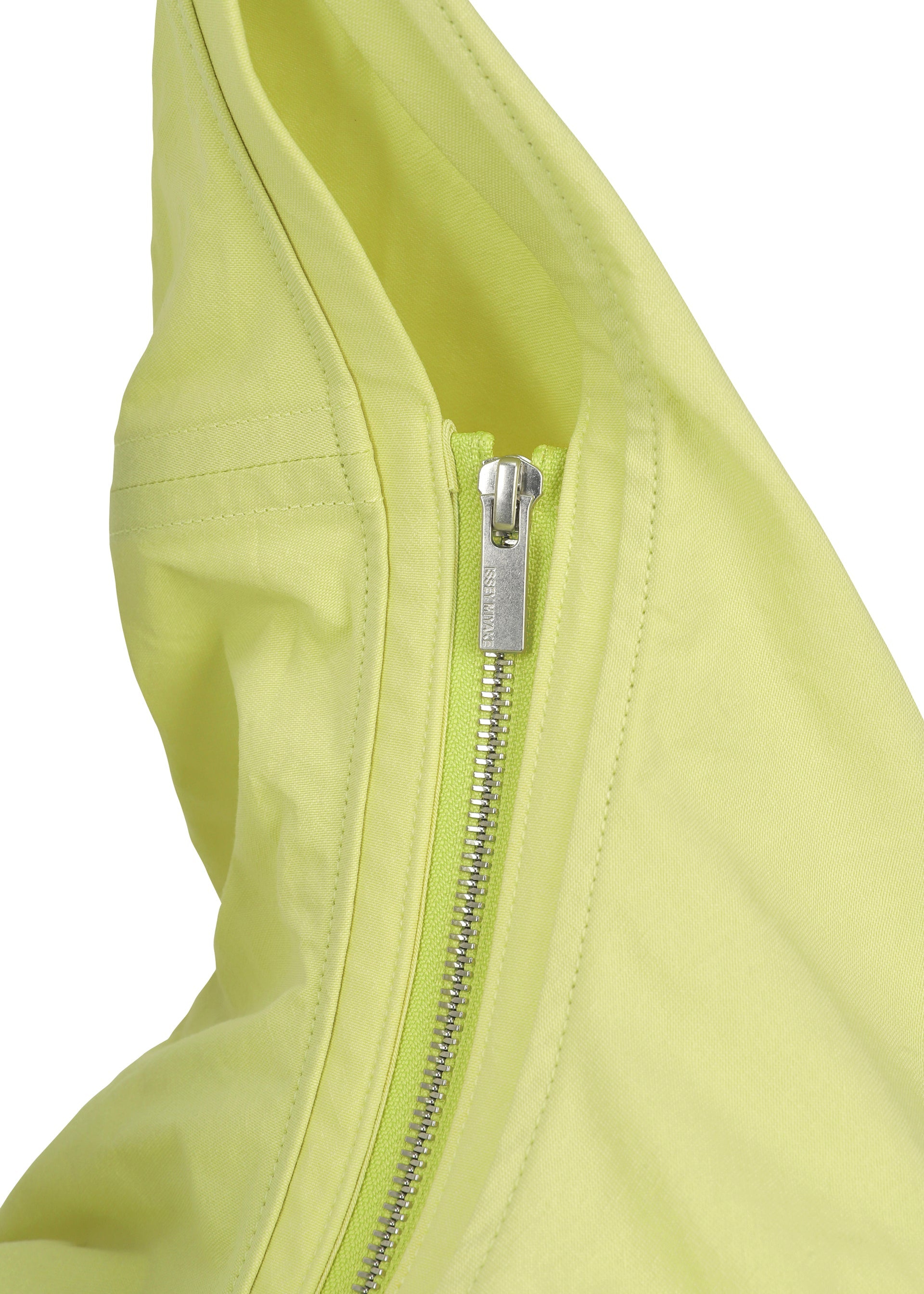Zoomed view Close-up of a silver zipper on crinkled light yellow fabric, evoking Japanese Washi paper—an iconic element in ISSEY MIYAKE's PAPER BALLOON 2 shoulder bag design.
