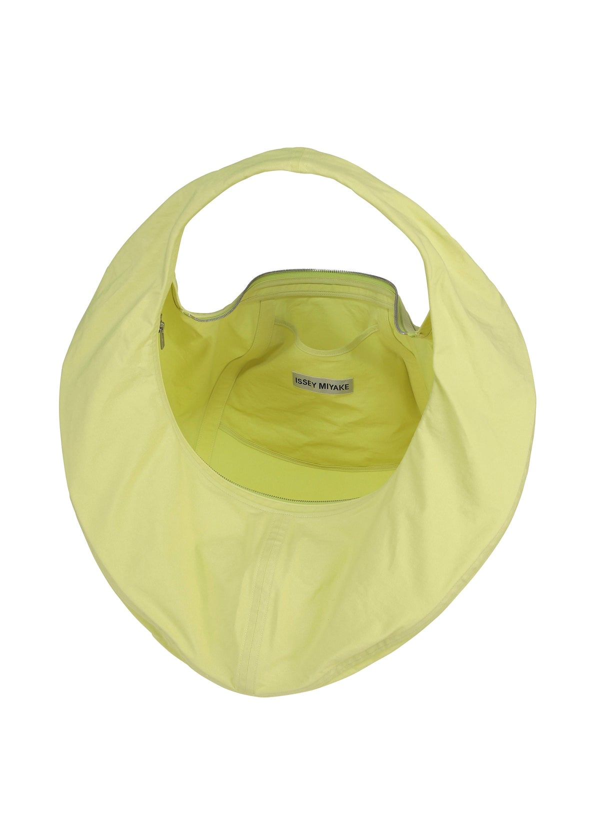 Top view of the ISSEY MIYAKE PAPER BALLOON 2—a light yellow, circular shoulder bag with a single handle, open zippered compartment, subtle crinkled texture like Washi paper, and visible inner label. view 4 of 6