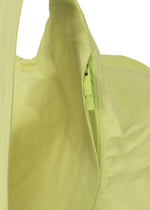 Close-up of the ISSEY MIYAKE PAPER BALLOON 2 backpack in light yellow, showcasing its matching yellow zipper and a fabric texture inspired by Japanese Washi paper, with the zipper pull clearly visible.