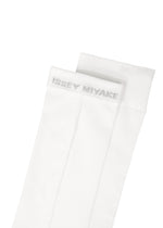 ISSEY MIYAKE SHEER SOCKS in white, featuring a subtle logo in light gray near the top cuff. The socks are neatly folded on a white background.