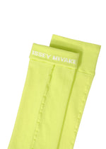 A pair of neon yellow SHEER SOCKS by ISSEY MIYAKE, featuring a white embroidered logo on the top cuff, displayed against a white background.