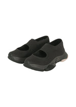 A pair of black KARST FINCH sneakers by ISSEY MIYAKE, featuring thick soles and wide cut-out openings on top, displayed on a white background—perfect lightweight sneakers for everyday comfort. - BLACK