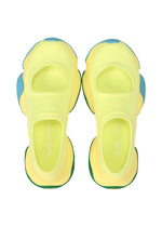 A pair of vibrant yellow ISSEY MIYAKE KARST FINCH sneakers with open tops, chunky rounded soles, and blue accents viewed from above on a white background—perfect lightweight shoes for a colorful look.
