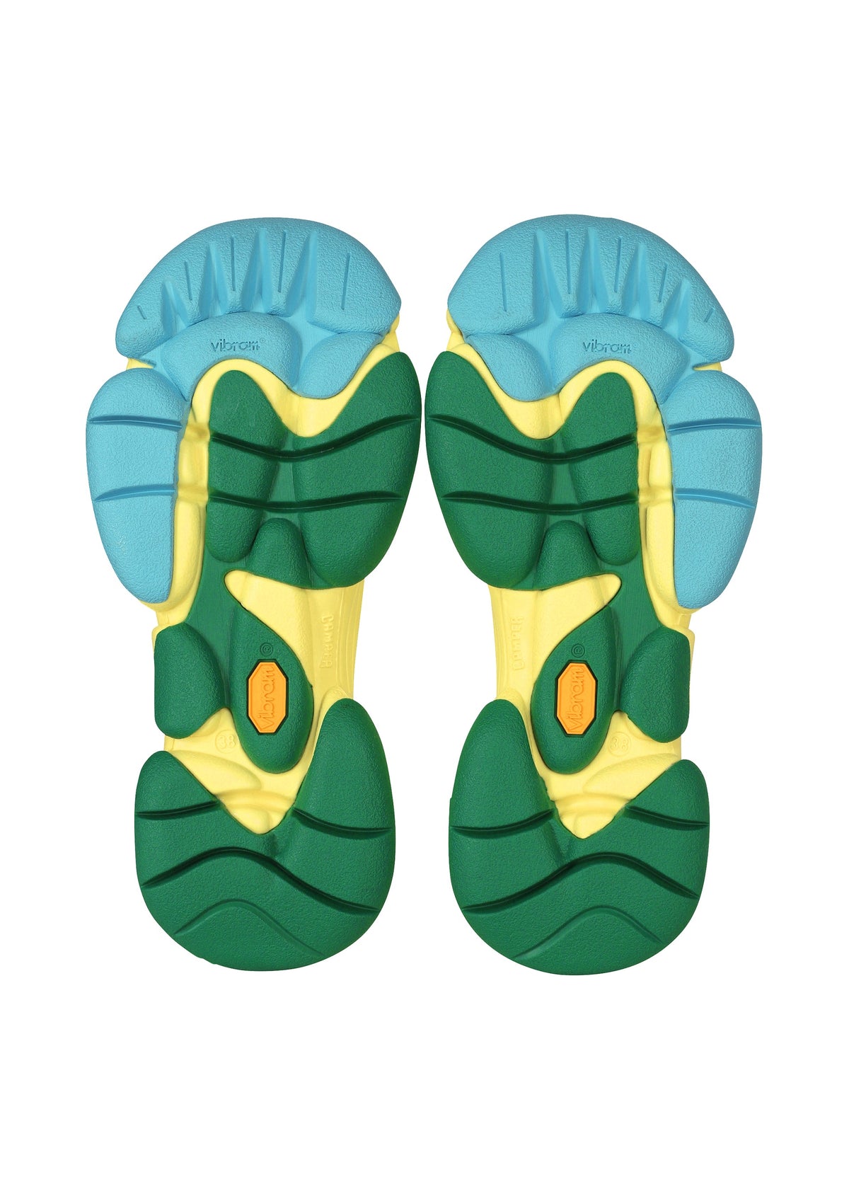 The chunky, segmented soles of the ISSEY MIYAKE KARST FINCH sneakers are seen from below, featuring blue, yellow, and green sections with black accents and a small orange hexagonal Vibram logo—reflecting their playful style. view 10 of 18