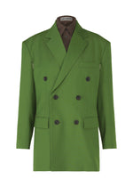 The ISSEY MIYAKE "PALINDROME" double-breasted green jacket features black buttons, notched lapel, flap and chest pockets, a striking design, and an inner collar tag reading ISSEY MIYAKE. Worn over a brown shirt. - DARK GREEN （no.63）