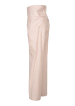 The GENERIC WEAR pants by ISSEY MIYAKE are light pink, high-waisted, and straight-legged, shown from the side with a button flap back pocket, belt loops, and tailored seams for a playful yet polished look.