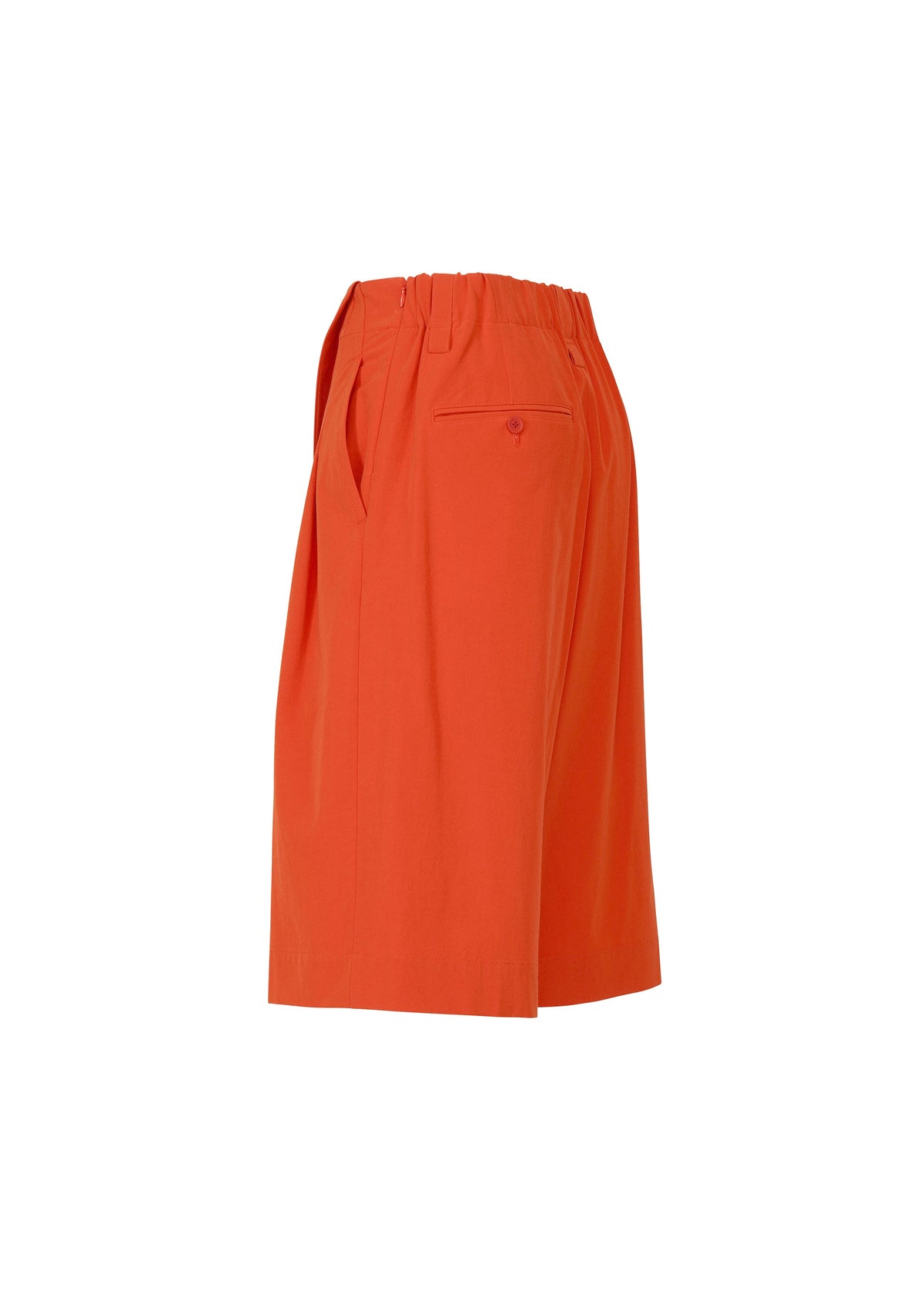 Side view of ISSEY MIYAKE's LOOPED shorts in bright orange, featuring a playful knee-length design, elastic waistband, stretch fabric, side pockets, and a buttoned back pocket, shown on a plain white background. view 4 of 8
