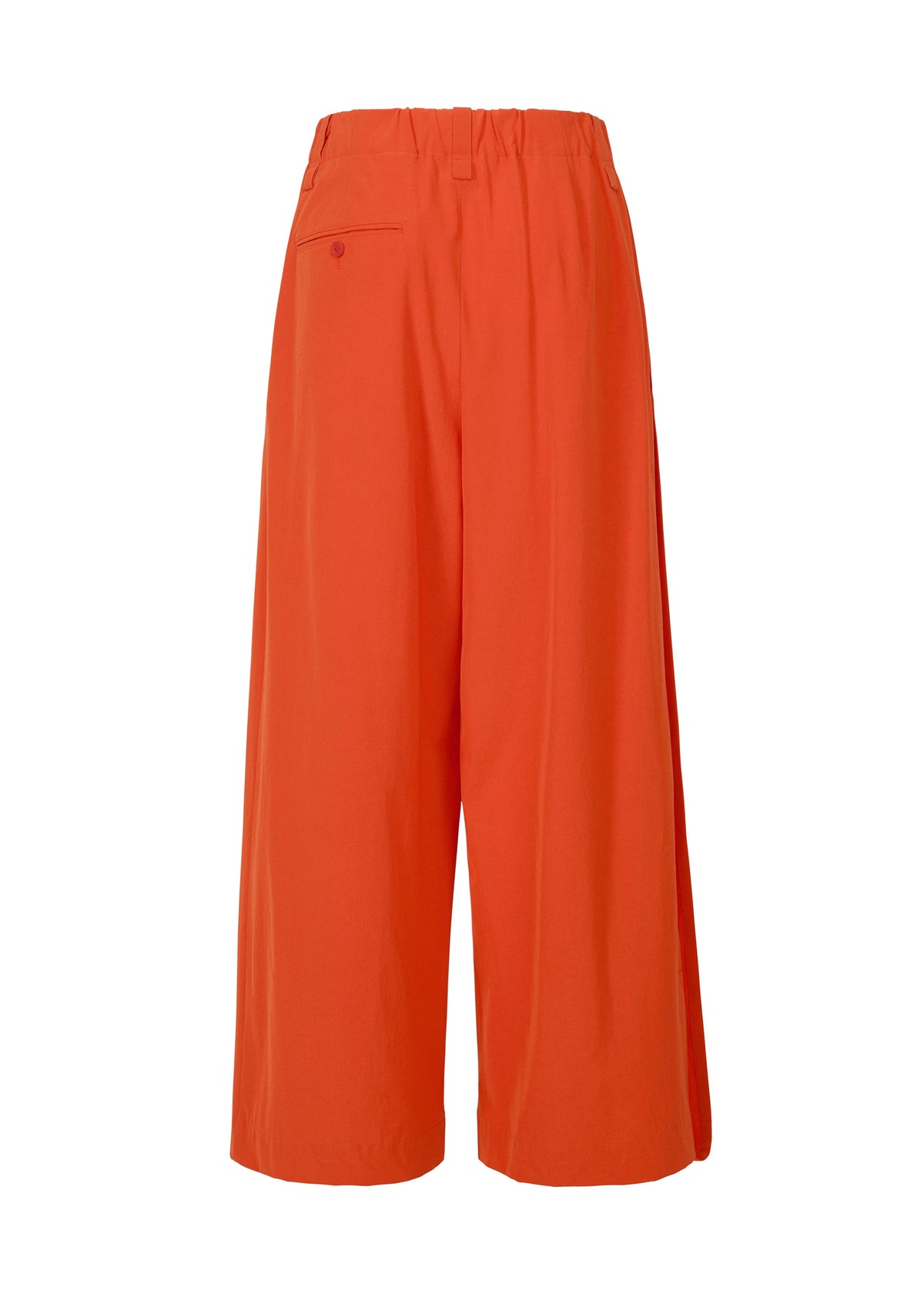 The LOOPED drapey stretch pants by ISSEY MIYAKE feature a bright orange hue, an elastic waistband, and a single buttoned back pocket, shown against a plain white background. view 3 of 9