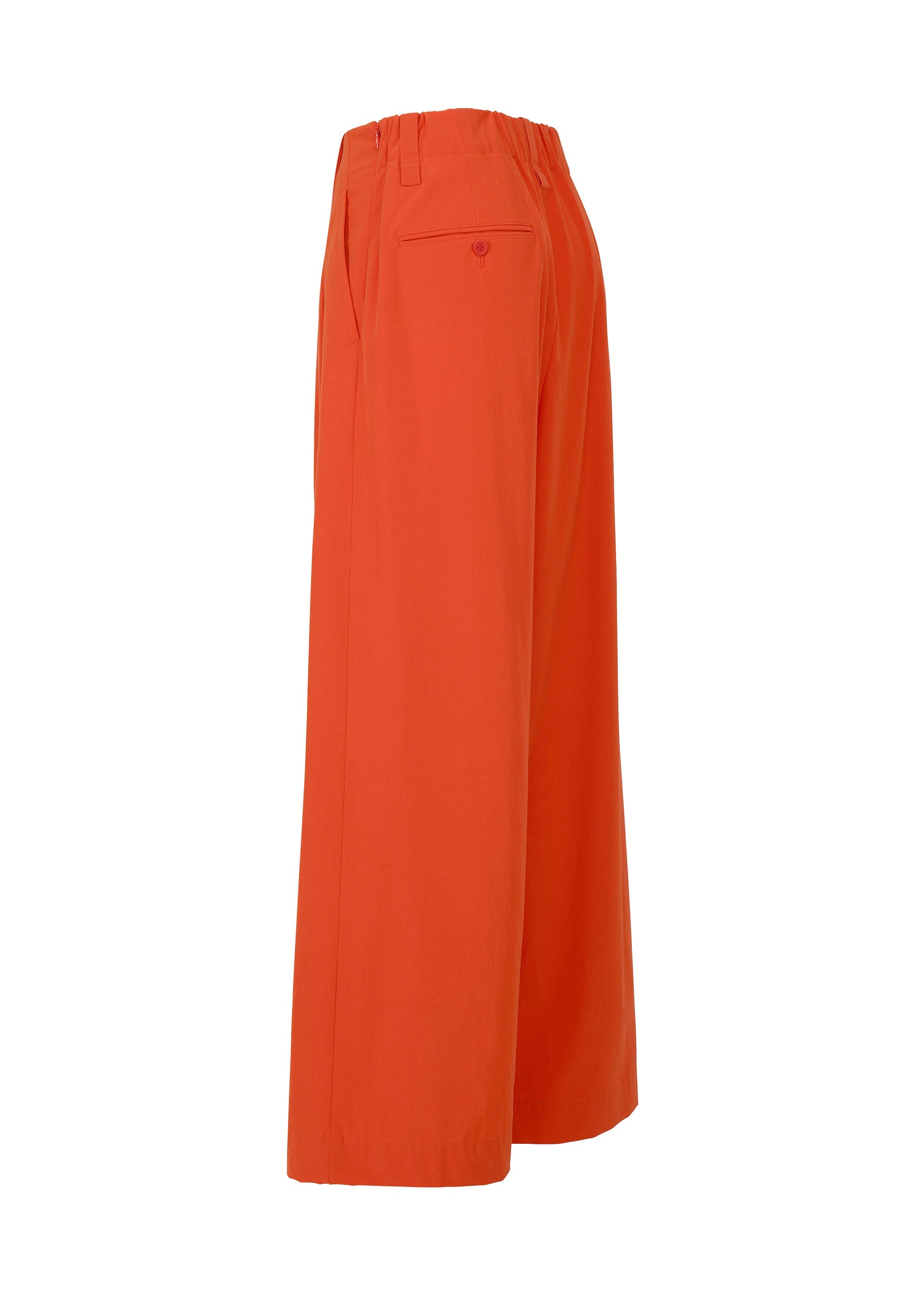 Zoomed view ISSEY MIYAKE's LOOPED pants feature a wide-leg, high-waisted orange drapey stretch design with an elastic waistband, unique belt loop, and back pocket, shown from the side against a white background.