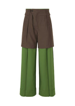PALINDROME high-waisted pants by ISSEY MIYAKE feature wide olive legs, layered brown shorts, a visible front fly, cuffed hems, and tailored seams—offering a modern, layered design inspired by the brand’s innovative style.