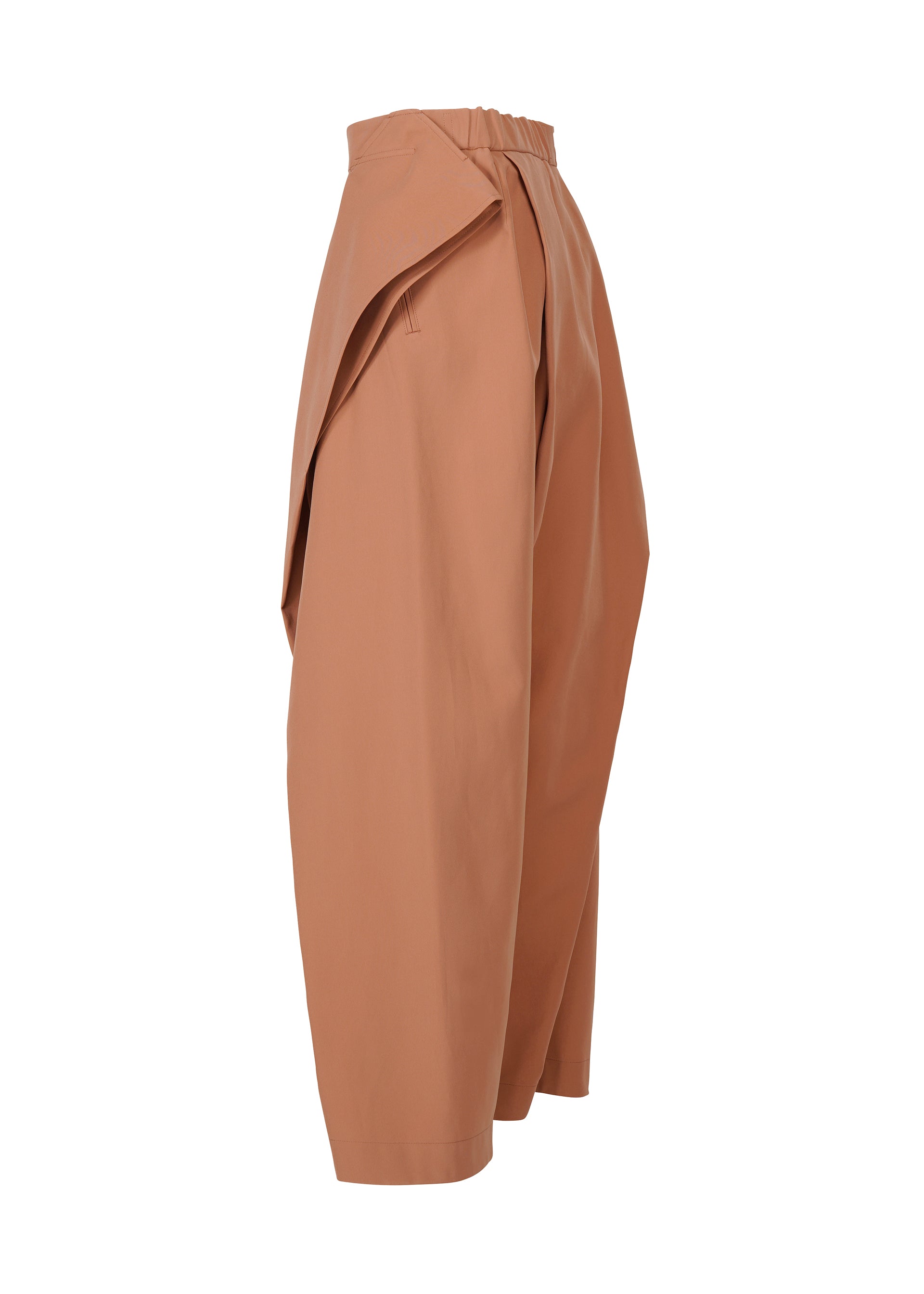 Zoomed view The FLUTTERING PANTS by ISSEY MIYAKE are high-waisted, loose-fitting light brown pants with wide legs and an asymmetric draped flap detail, displayed on a white background.