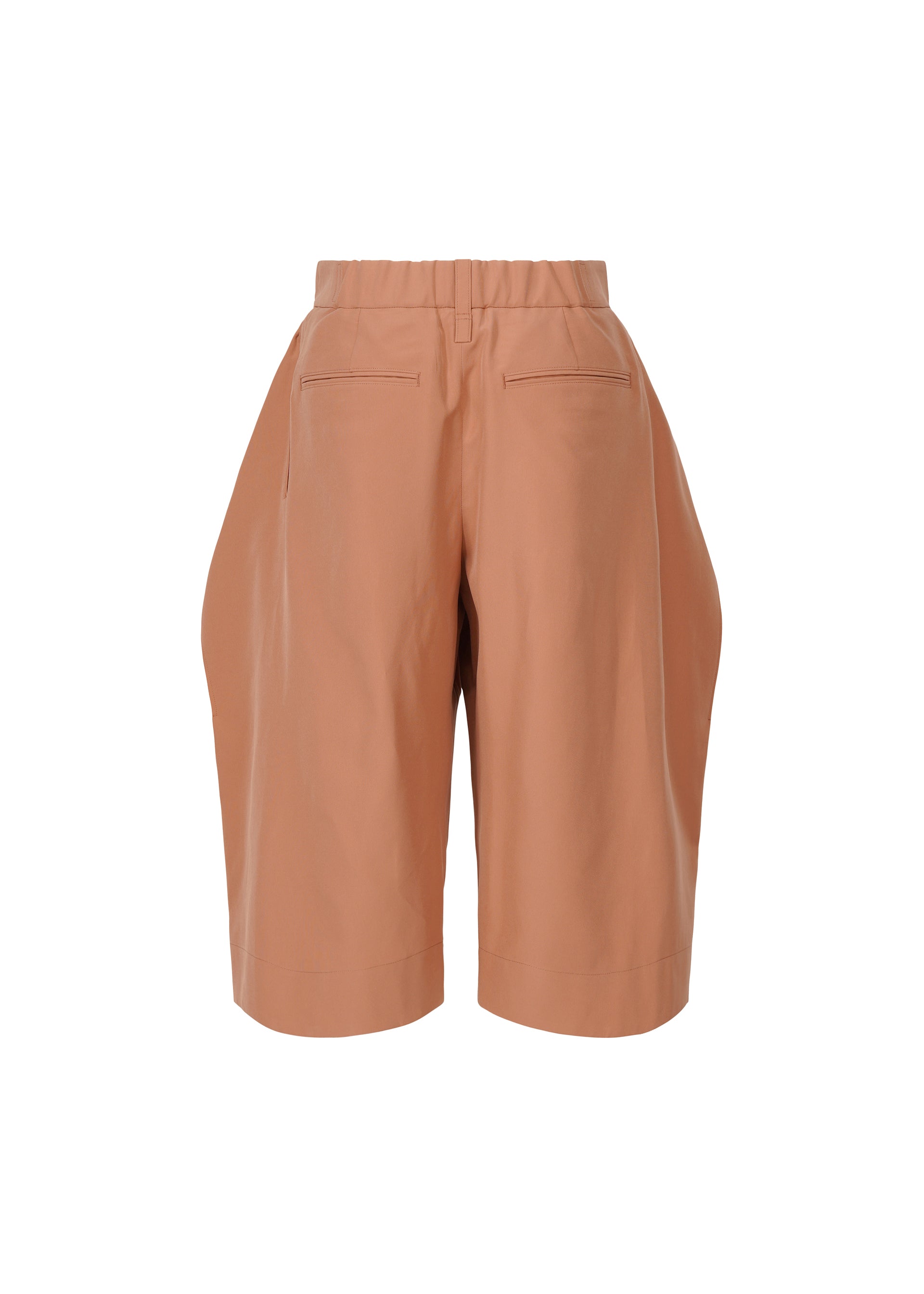 Zoomed view ISSEY MIYAKE FLUTTERING PANTS: High-waisted, knee-length terracotta shorts with elastic waistband, front pleats, back welt pockets, and a subtle matte double-woven texture, shown against a white background.
