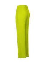 The BOX SHOULDER PLEATS pants by ISSEY MIYAKE feature a bright yellow-green hue, elastic waistband, and wide-leg double-pleated design. Shown from a rear three-quarter angle, the unique pleats and textured fabric stand out against a white background.