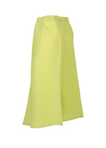 The ISSEY MIYAKE PLASTER PLEATS SOLID is a light yellow, calf-length A-line skirt made from recycled polyester, featuring subtle diagonal stripes and an elastic waistband, displayed against a white background.