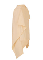 The CONCEALED skirt by ISSEY MIYAKE is a light beige, asymmetrical wrap skirt made from textured cotton with overlapping panels and a button waist closure, shown against a plain white background.