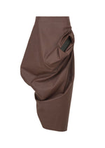 The ISSEY MIYAKE PEU FORM³ is a brown asymmetric faux leather skirt from the Autumn Winter 2025/26 Collection, featuring an abstract drape and large gathered side pocket. Smooth, modern finish. Shown on a plain white background. - DARK BROWN (no.45)