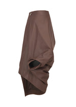 The PEU FORM³ skirt by ISSEY MIYAKE from the Autumn Winter 2025/26 Collection features asymmetrical brown artificial leather, a draped sculptural silhouette, high-low hemline, waist zipper, and layered fabric for voluminous folds on one side.