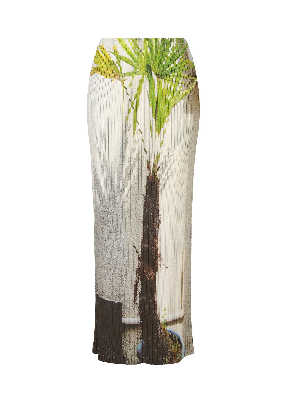 The URBAN JUNGLE PLEATS skirt by ISSEY MIYAKE is an ankle-length, ribbed design showcasing a vivid palm pattern on a textured white base, blending nature and fashion for a bold jungle-inspired look. view 1 of 7
