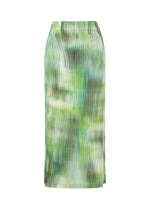 The OBSCURE PLEATS skirt by ISSEY MIYAKE is a long, pleated polyester piece with a green and white tie-dye pattern, shown against a plain white background. - GREEN-HUED (no.66)