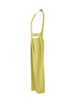 Side view of ISSEY MIYAKE BELTED WOOL PANTS in light yellow, high-waisted with wide suspenders and pleated waist, crafted from a soft wool blend fabric, shown on a plain white background.
