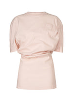 The ISSEY MIYAKE GENERIC WEAR top is light pink with short sleeves, a round neck, and a small left chest pocket featuring a playful design, shown on a plain white background. - LIGHT PINK （no.21）