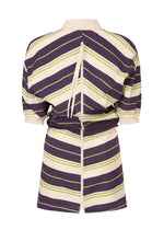 The ISSEY MIYAKE GENERIC WEAR: STRIPES tunic features cream, purple, and olive green diagonal stripes, a cream collar, back zipper with neck tie, slightly cinched waist, and mid-thigh hem for a modern twist.