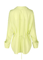 Back view of the ISSEY MIYAKE ODD SHIRT 2 in light yellow high-twist cotton voile, featuring a waist belt tie, loose fit, and folded cuffs for versatile styling.