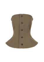 The ARMS bustier corset by ISSEY MIYAKE features a brown, strapless, hourglass silhouette with five large front buttons. Its structured fabric is tailored to a curved waist and flares gently at the bottom hem. - DARK BROWN (no.45)