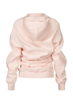 The ISSEY MIYAKE GENERIC WEAR hoodie in light pink features playful back detailing, long sleeves, ribbed cuffs and waistband, all displayed on a white background.