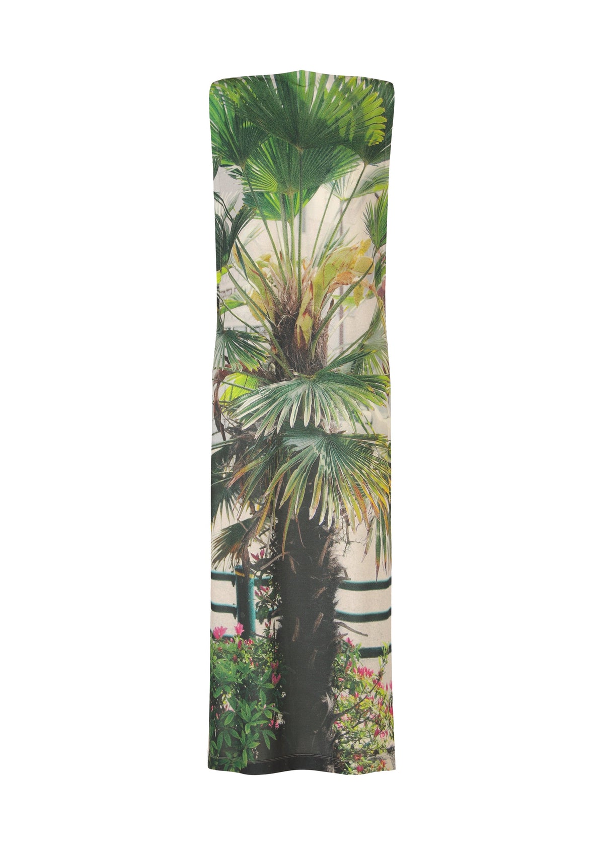 The URBAN JUNGLE JERSEY dress by ISSEY MIYAKE is a sleeveless, floor-length gown in soft jersey with a lively jungle greenery print featuring palm fronds, a brown trunk, and pink flowers on a light background. view 2 of 6