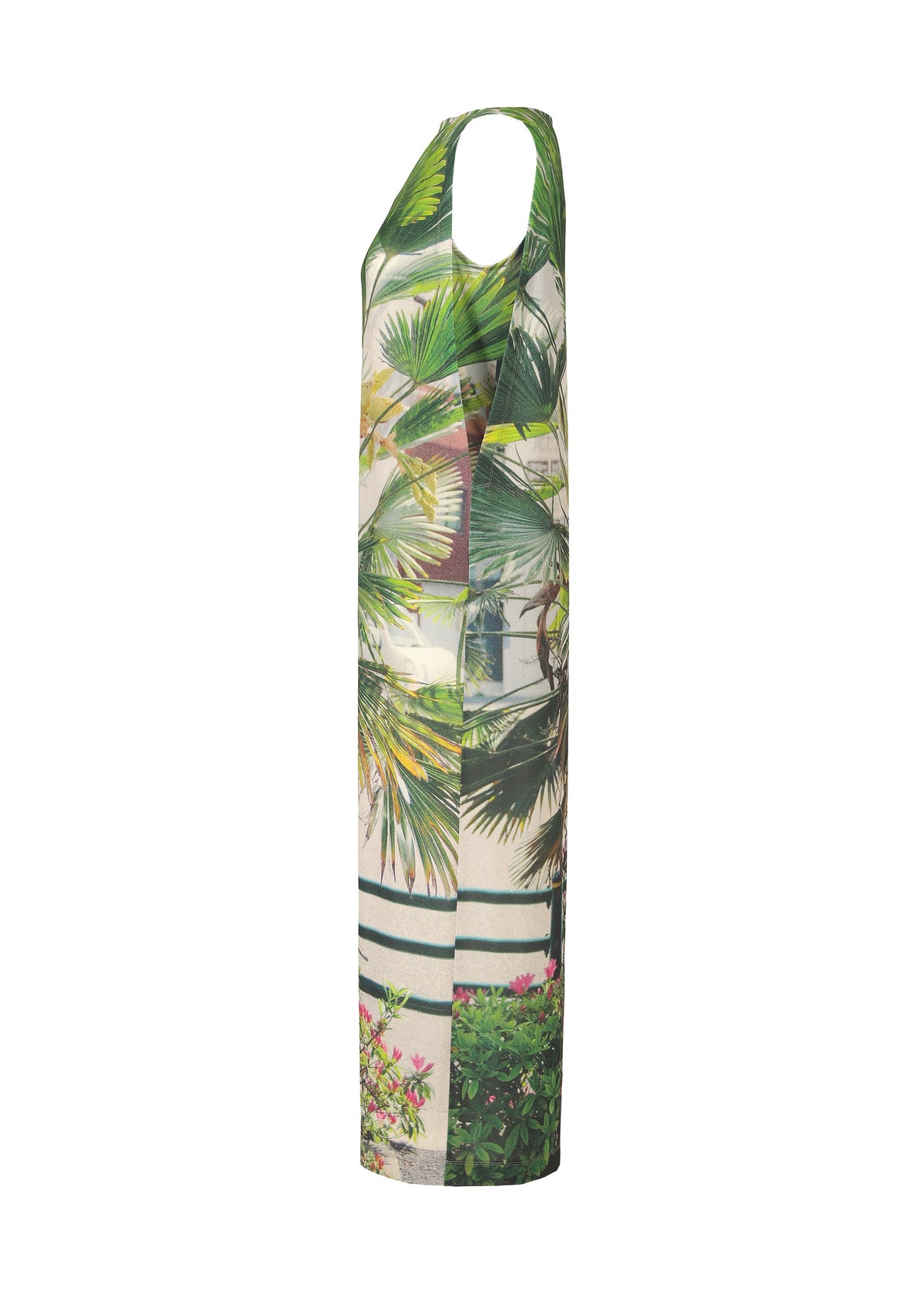 The ISSEY MIYAKE URBAN JUNGLE JERSEY is a sleeveless, long dress with a vibrant jungle greenery print featuring green palm leaves and foliage on a light background, shown in a side view. view 4 of 6