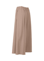 The ISSEY MIYAKE CAMPAGNE wide-leg, high-waisted beige culottes are made from stretchy A-POC fabric, with a gathered elastic waistband and loose, flowing silhouette, shown in a side view against a white background.