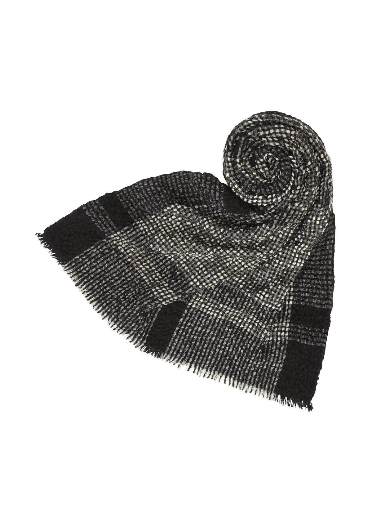 The BUMPY WOOL STOLE by ISSEY MIYAKE features a black and gray plaid pattern with fringed edges, partially rolled into a spiral on a white background to highlight its subtly bumpy texture. view 2 of 5
