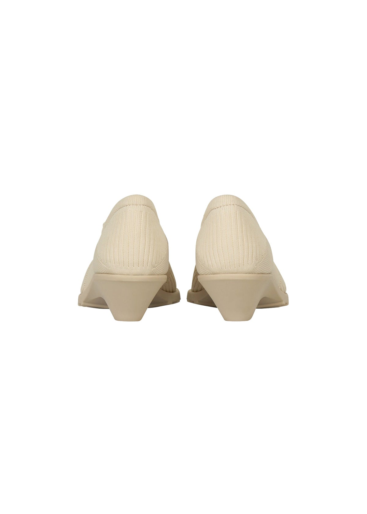 Back view of a pair of beige, low-heeled, closed-toe ISSEY MIYAKE ANNA shoes with a textured fabric upper reminiscent of knitted footwear, set against a plain white background. view 4 of 9